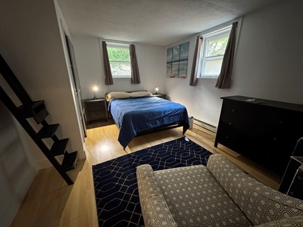 Provincetown Cape Cod vacation rental - Bedroom with night tables, reading chair, dresser and closet.