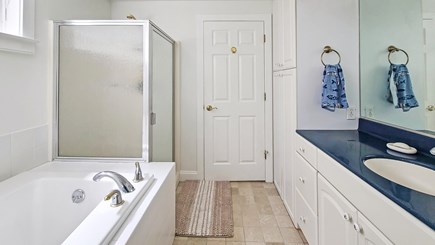 Wellfleet Cape Cod vacation rental - First floor primary ensuite bathroom with separate tub and shower