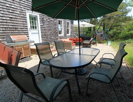 Truro Cape Cod vacation rental - outdoor dining with couch in background