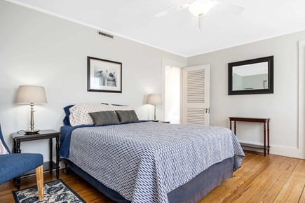 Bourne, Buzzards Bay Cape Cod vacation rental - A cozy bedroom escape with soft hues and nautical charm.