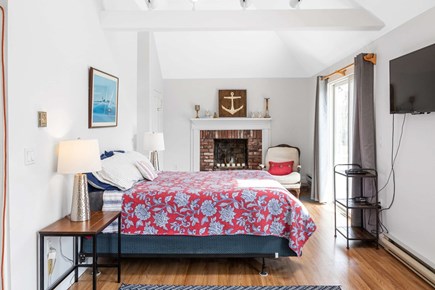 Bourne, Buzzards Bay Cape Cod vacation rental - A cozy bedroom with a floral bedspread, brick warmth, and charm.