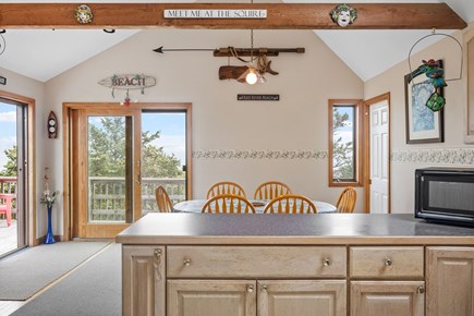 Harwich Cape Cod vacation rental - Look from kitchen toward dining area with sliders to upper deck