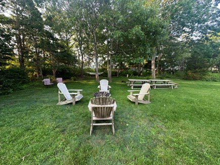 Dennis Cape Cod vacation rental - Expansive backyard with fire pit and picnic tables