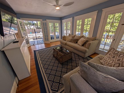 Harwich Cape Cod vacation rental - Light-filled sunroom with door to wrap-around deck