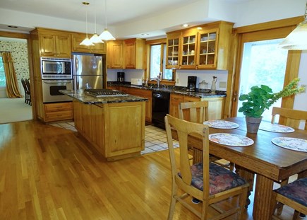 East Sandwich Cape Cod vacation rental - Kitchen with small dining area and door to deck 