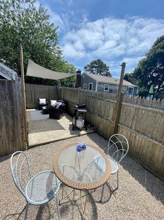 Dennisport Cape Cod vacation rental - Outdoor patio complete with a grill and a comfortable patio set