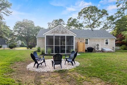 East Dennis Cape Cod vacation rental - Back Yard with Firepit, Outdoor shower and Screened patio area.