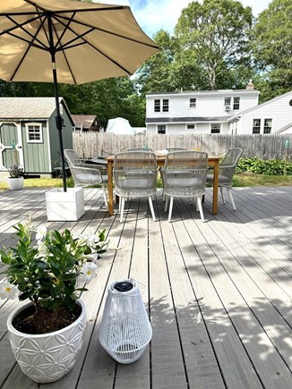 Mashpee Cape Cod vacation rental - Outdoor space with table and grill; shed with beach chairs/wagons