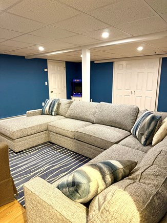 Mashpee Cape Cod vacation rental - Media room in finished basement with TV and pac man.  W/D too