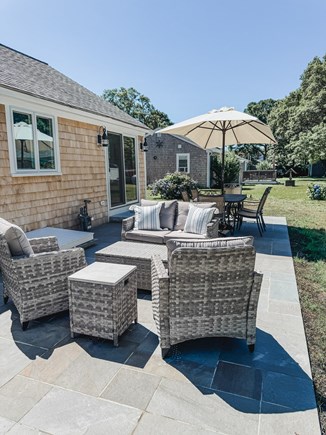 South Yarmouth Cape Cod vacation rental - Backyard - patio, living and dining area.  Fence coming fall 2025