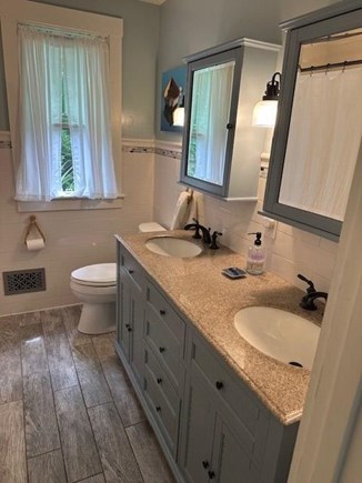 Harwich Cape Cod vacation rental - Bathrooms offers two sinks, storage and bathtub/shower