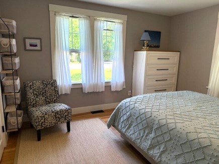 Harwich Cape Cod vacation rental - Queen bedroom with bright sun, dresser and chair.