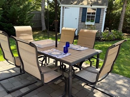 Harwich Cape Cod vacation rental - Relax at the umbrella patio table with auto-lighting at sunset.