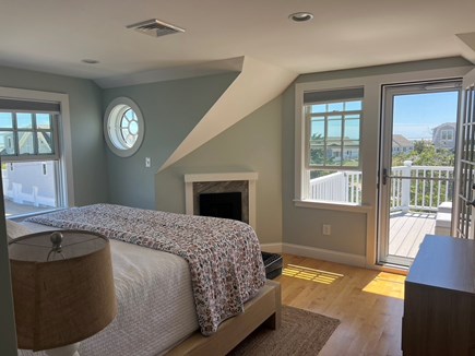 Chatham, Little Beach Cape Cod vacation rental - Primary bedroom complete with fireplace and private balcony.