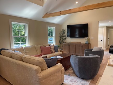 Harwichport Cape Cod vacation rental - Living room with custom upholstered sectional and 65" smart tv.
