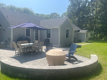 Harwichport Cape Cod vacation rental - Outdoor patio with sitting wall, Weber grill & propane fire pit