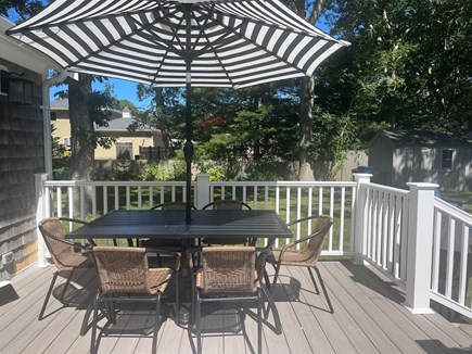 Falmouth Heights Cape Cod vacation rental - Deck area, table for 6, two reading chairs, gas grill