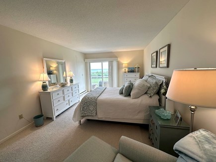 West Harwich Cape Cod vacation rental - Primary bedroom with queen-sized bed and direct access to deck