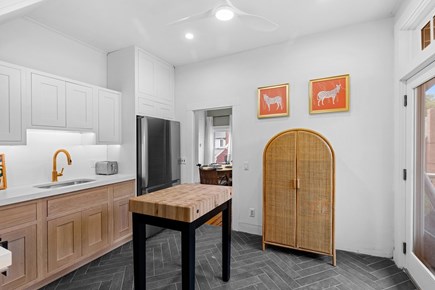 Provincetown Cape Cod vacation rental - The kitchen features a butcher block island and herringbone floor