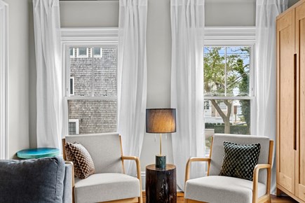 Provincetown Cape Cod vacation rental - Sunlight streams through large windows framing cozy accent chairs