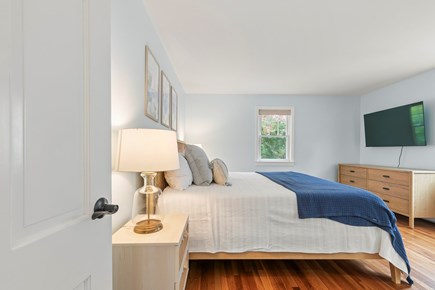 West Falmouth Cape Cod vacation rental - First floor bedroom with King bed + TV.
