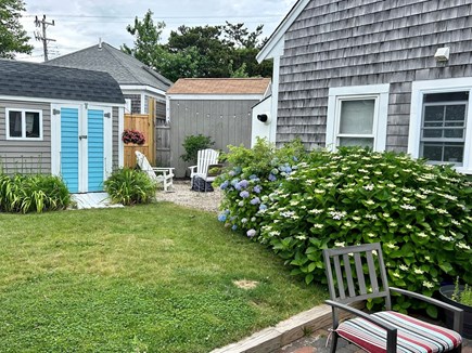 South Yarmouth Cape Cod vacation rental - Private yard with grill, shower, and dining table/umbrella