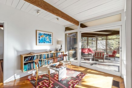 Wellfleet, Griffins Island Hideaway Cape Cod vacation rental - Cozy reading nook with built-in bookcase and access to the porch