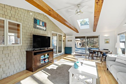 Eastham Getaway Cape Cod vacation rental - Media wall and cozy sitting area with patio access