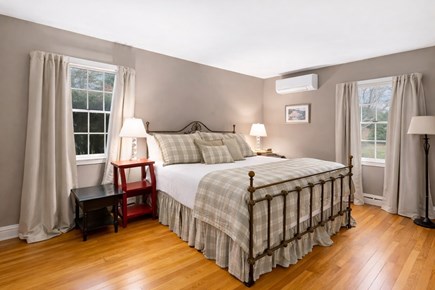 Centerville, Firefly Landing Cape Cod vacation rental - Primary queen bedroom with mini-split AC, coastal tones.