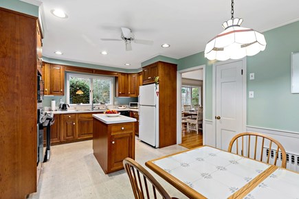 Centerville, Firefly Landing Cape Cod vacation rental - Kitchen with island, gas range, and breakfast table.