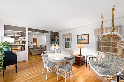 Centerville, Firefly Landing Cape Cod vacation rental - Sitting room with built-ins, round table, rattan chair.