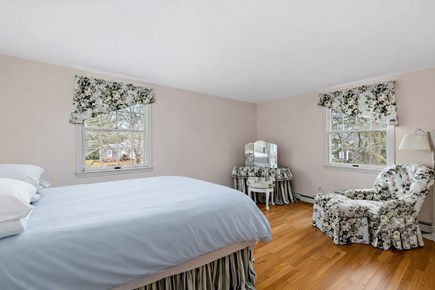 Centerville, Firefly Landing Cape Cod vacation rental - Spacious bedroom with sitting chair and sunny windows.