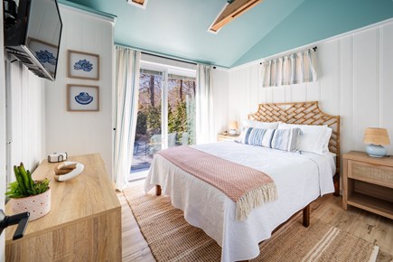 Truro Cape Cod vacation rental - Primary bedroom with queen bed and peaceful patio access & views.