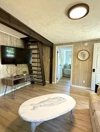 Falmouth Cape Cod vacation rental - Open living space with wood floors and stair access upstairs