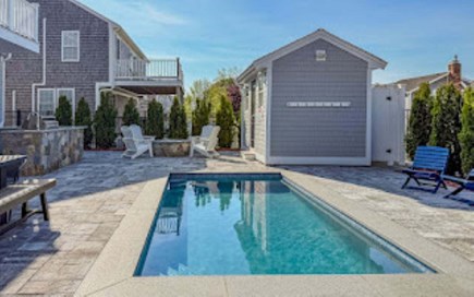 Sandwich Cape Cod vacation rental - 4 foot deep heated plunge pool with fire pit and adirondack chairs perfect for family gatherings.  Outdoor shower located to the right of the house.