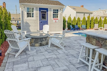 Sandwich Cape Cod vacation rental - Beautifully designed fire pit with comfortable Adirondack chairs overlooking the beautiful pool.   Stools at the outdoor bar and grill