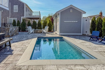 Sandwich Cape Cod vacation rental - 4 foot deep heated plunge pool with fire pit and Adirondack chairs perfect for family gatherings.  Outdoor shower located to the right of the house.