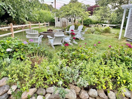 West Harwich Cape Cod vacation rental - Fire Pit with Adirondack Chairs Surrounded by Gardens