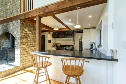 Chatham, Marshlight Retreat Cape Cod vacation rental - Breakfast bar seating beside the statement stone fireplace