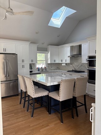 Falmouth Cape Cod vacation rental - Kitchen with dishes, silverware, glasses, oven, stove, etc.