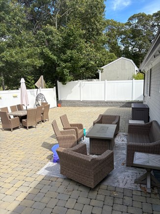 Falmouth Cape Cod vacation rental - Patio with outdoor dining table and lounge section with firepit
