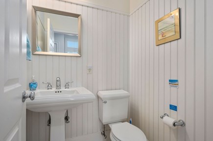 Chatham Cape Cod vacation rental - A convenient half bathroom is located by the stairs in the main living space of the home