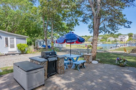 Mashpee Cape Cod vacation rental - communal patio with grill and dining table