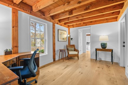 Centerville Cape Cod vacation rental - Cozy den featuring a work desk, charging station, and a plush lounge chair for relaxing or working.