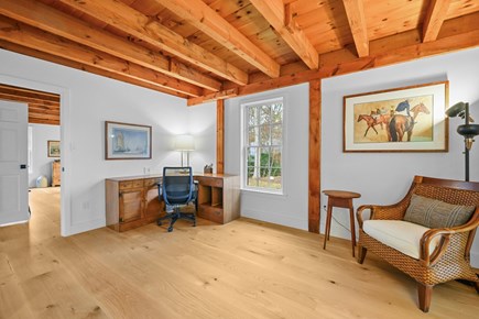 Centerville Cape Cod vacation rental - Den with a desk, charging station, and comfortable lounge chair.