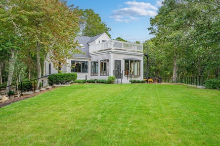 Centerville Cape Cod vacation rental - Backyard with lush greenery