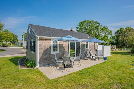 West Dennis Cape Cod vacation rental - Back patio with dining table and sitting area