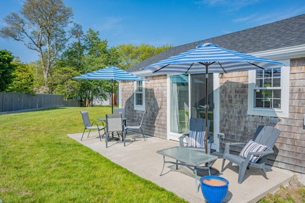 West Dennis Cape Cod vacation rental - Back patio with dining table and sitting area