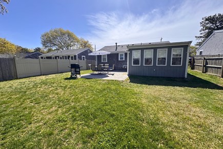 West Yarmouth Cape Cod vacation rental - View of patio area from the backyard
