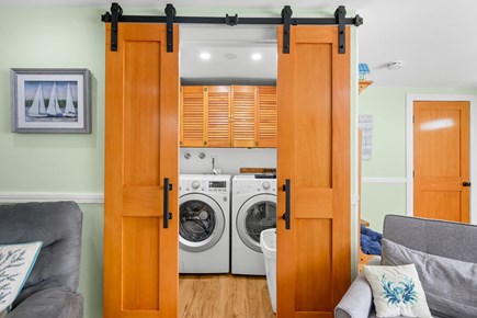 West Yarmouth Cape Cod vacation rental - Laundry area tucked behind barn doors